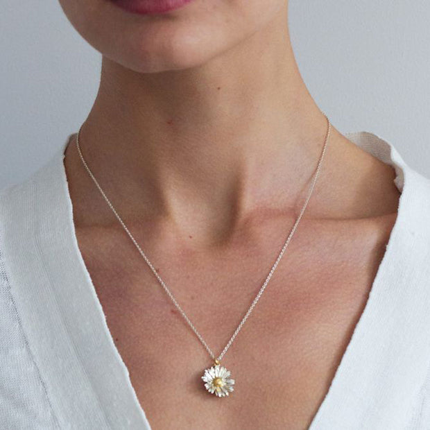 Daisy Necklace, is made from sterling silver and gold vermeil.