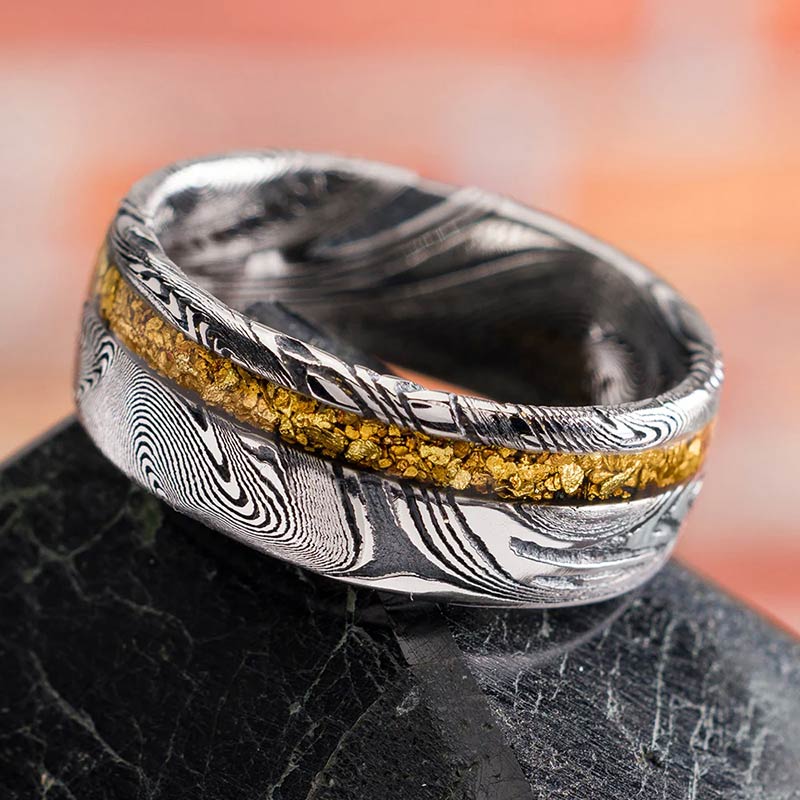Unique damascus steel men's wedding band with marble designs.
