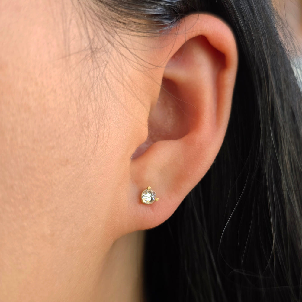 Woman wearing Turned Light inverted diamond studs by Todd Pownell from Alara Jewelry