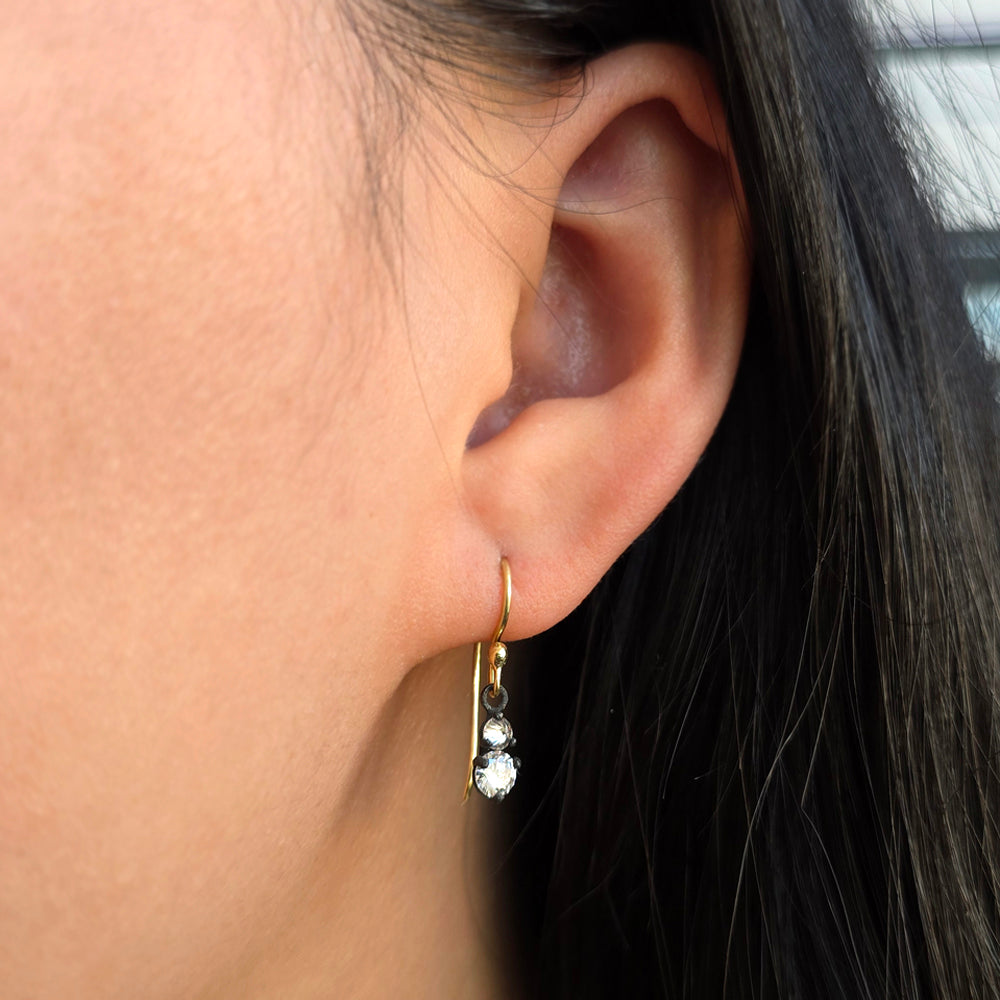 Woman wearing Twin Signal diamond drop earrings by Todd Pownell from Alara Jewelry