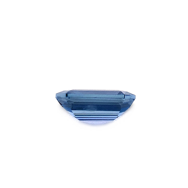 Side view showing stepped facets of an emerald-cut unheated deep blue color Yogo sapphire.