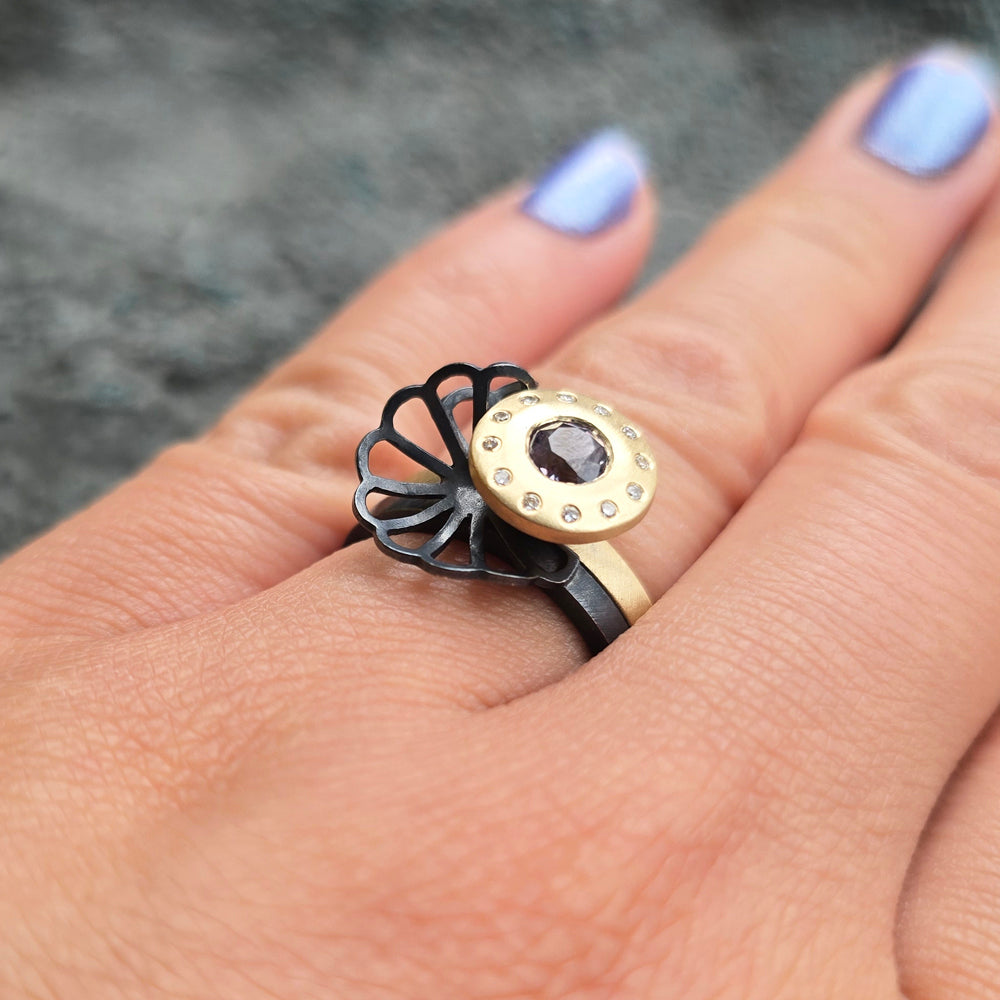 Woman wearing Montana sapphire ring set with origami accent from Alara Jewelry