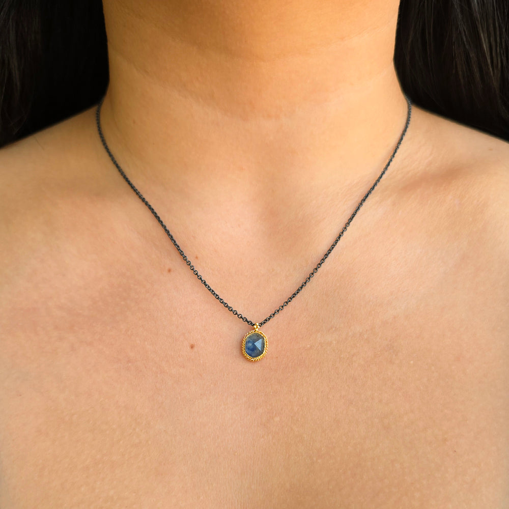 Woman wearing Skybound Montana sapphire necklace from Alara Jewelry