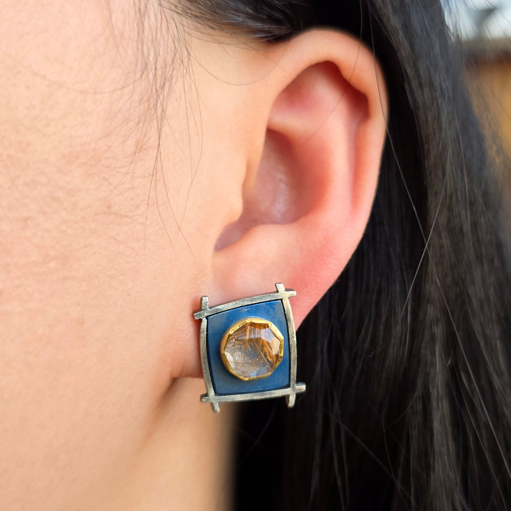 Woman wearing rutilated quartz stud earrings with gold and titanium detailing from Alara Jewelry
