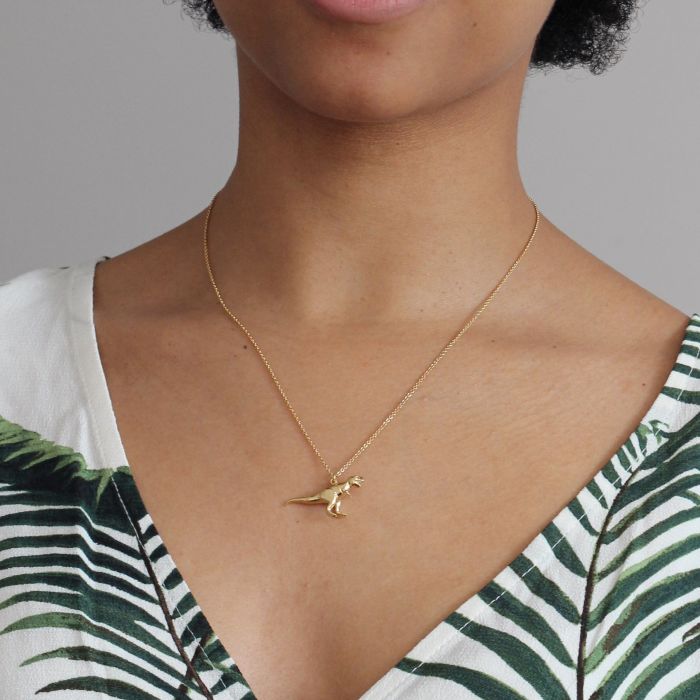 Woman wearing T-Rex pendant necklace by Alex Monroe from Alara Jewelry
