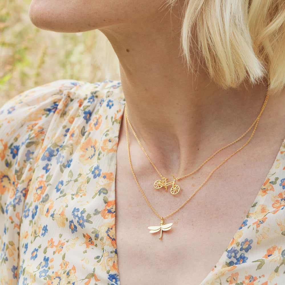 Woman wearing dragonfly pendant necklace by Alex Monroe from Alara Jewelry