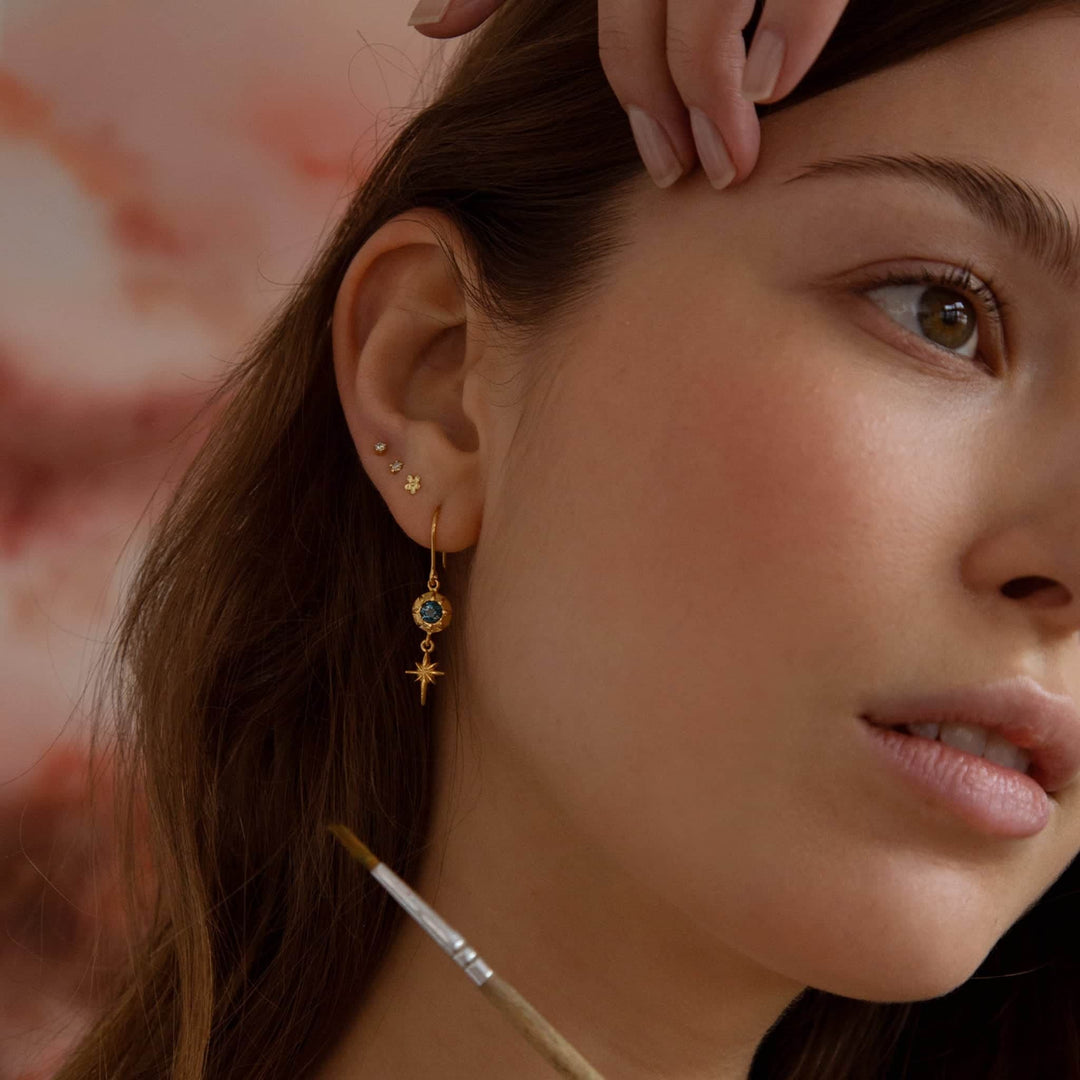 Woman wearing Guiding Star topaz earrings by Alex Monroe from Alara Jewelry