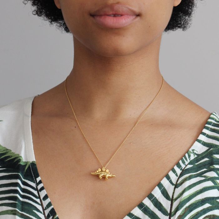 Woman wearing Stegosaurus pendant necklace by Alex Monroe from Alara Jewelry