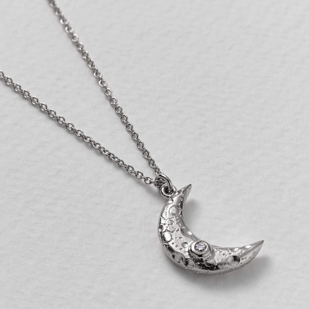 Textured crater crescent moon pendant with natural diamond accent