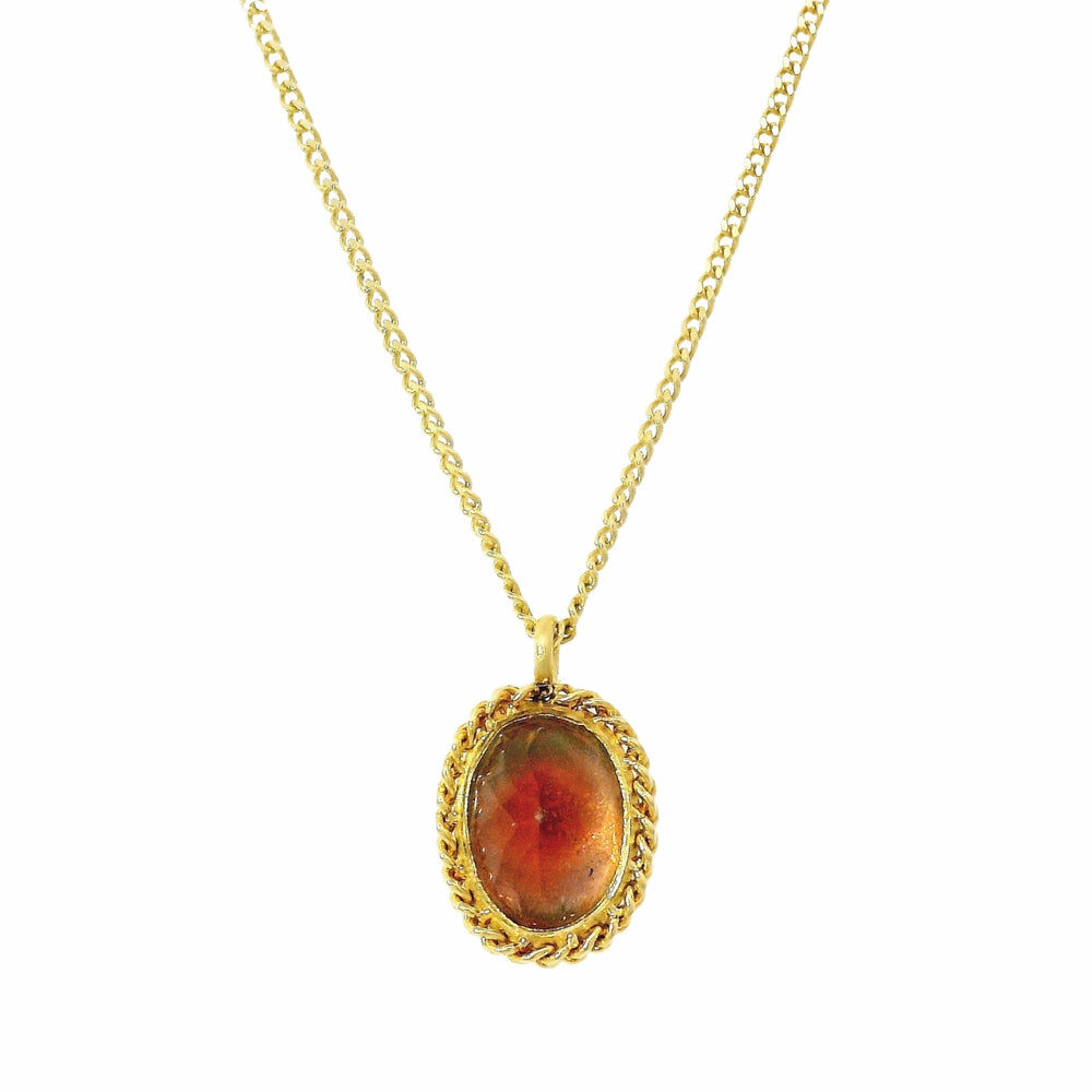 Close-up of sunstone showing amber, peach, and plum color variation