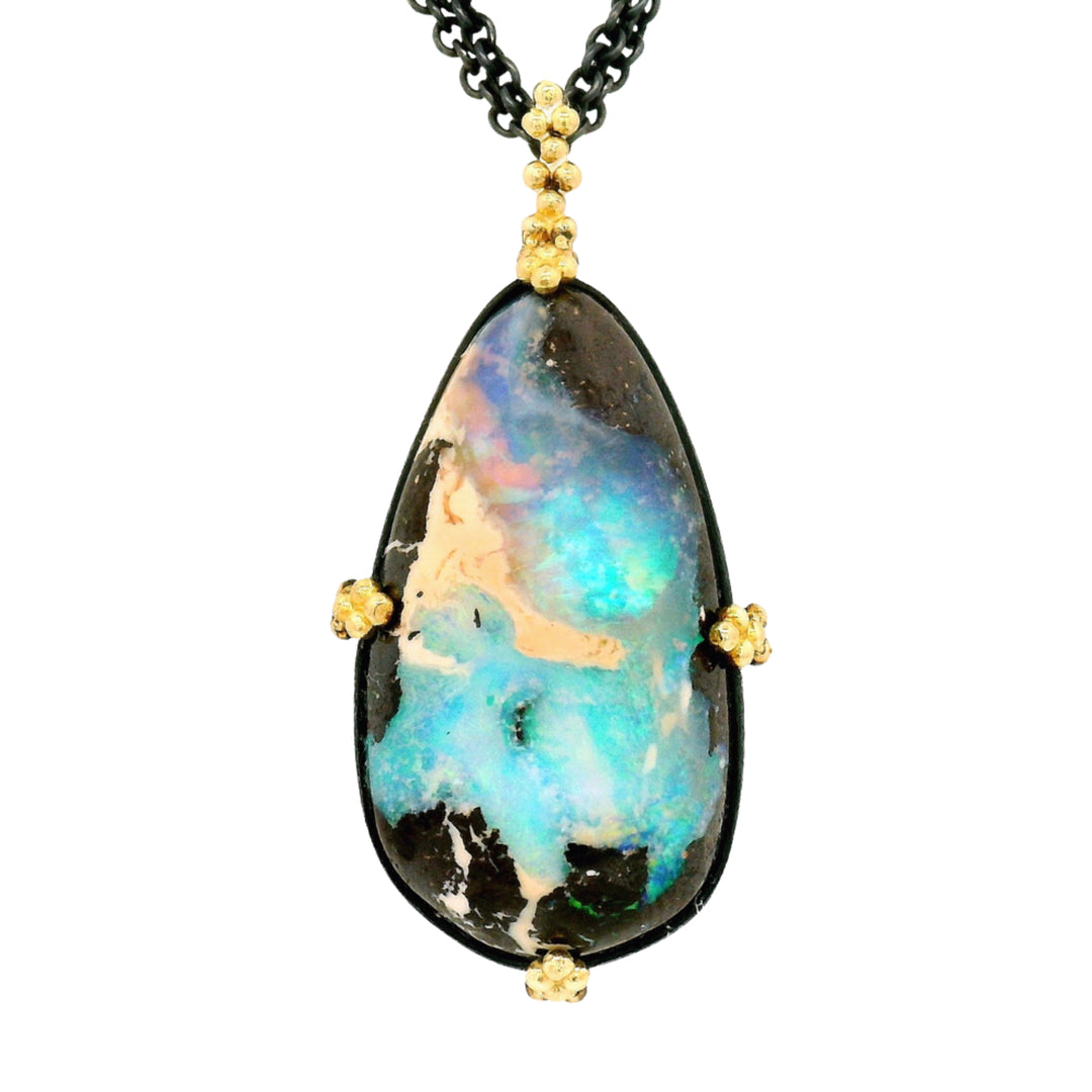 Close-up of boulder opal showing vivid green, blue, and gold play-of-color