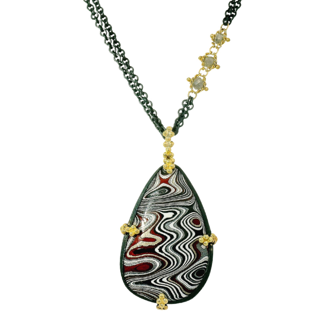 One-of-a-kind Fordite pendant necklace by Amáli in oxidized silver and gold