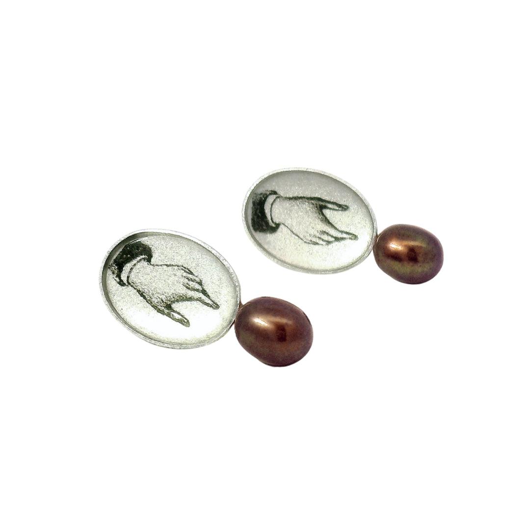 Close-up of hand-illustrated oval earring with pearl detail