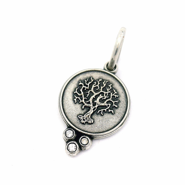 Close-up of sculpted Tree of Life pendant with bezel-set diamonds