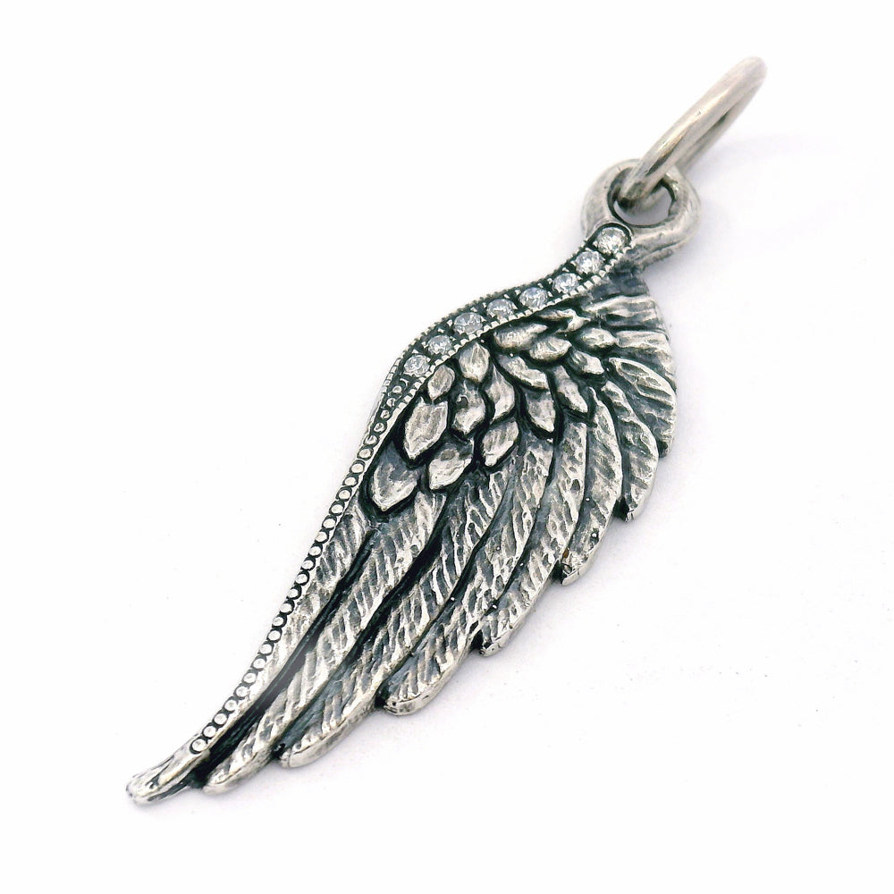 Silver wing-shaped pendant on a white background