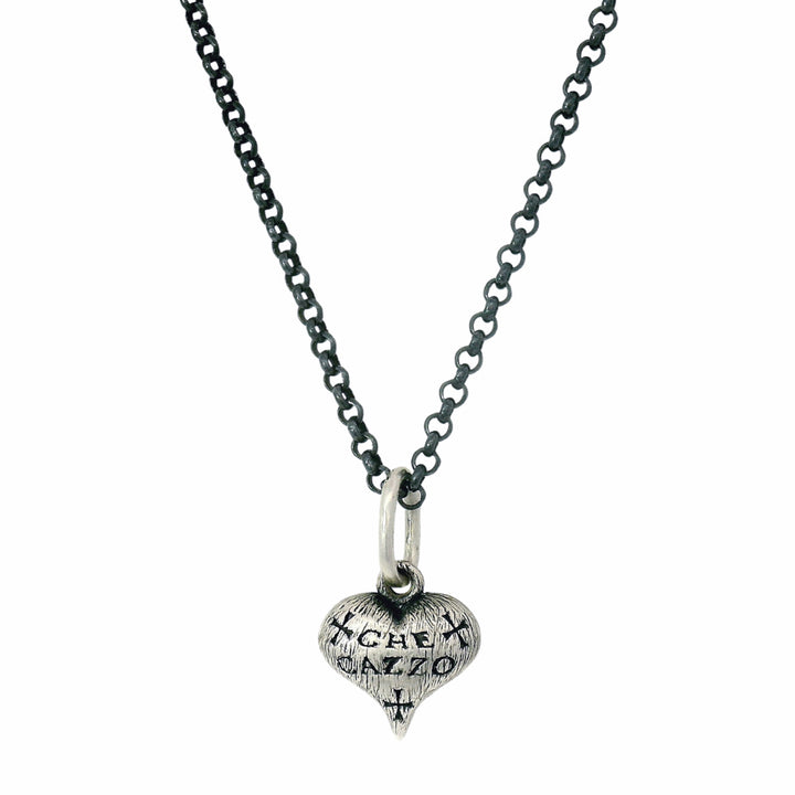 Hand-carved sterling silver heart charm by Erica Molinari with engraved detail