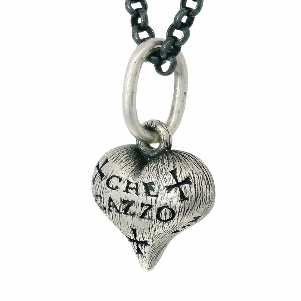 Hand-carved sterling silver heart charm by Erica Molinari with engraved detail