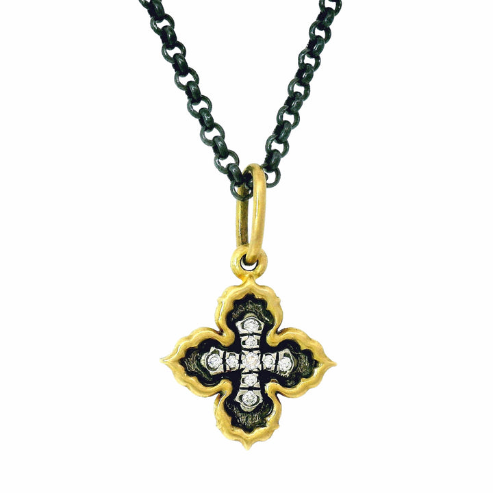 Reversible quatrefoil diamond cross charm by Erica Molinari in gold and silver