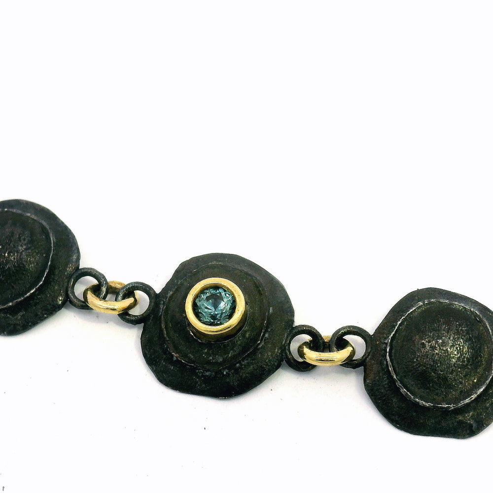 Textured oxidized sterling silver link bracelet with yellow gold and sapphire accents