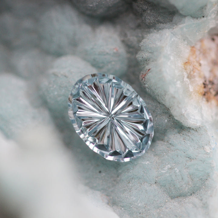Faceted gemstone on a textured stone background