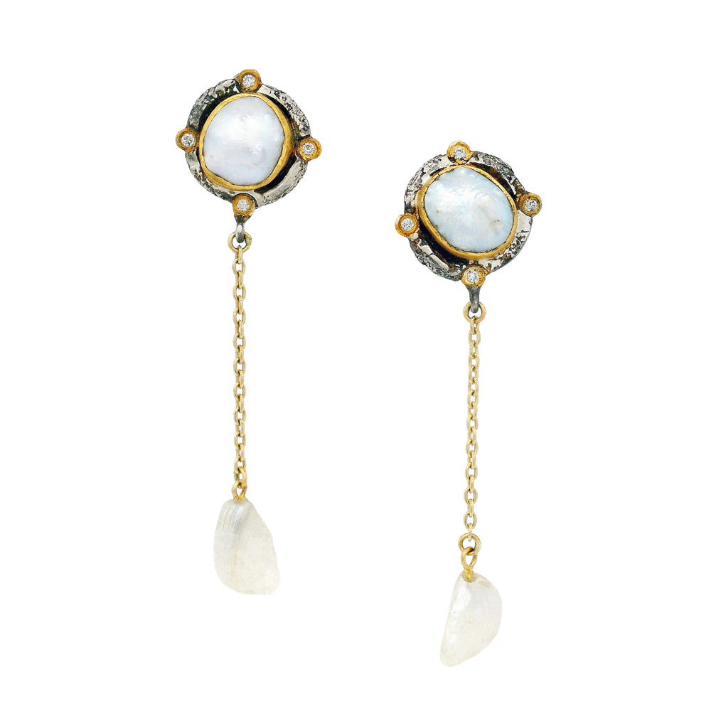 Close-up of natural pearl earrings featuring 22K gold and diamond cardinal point accents