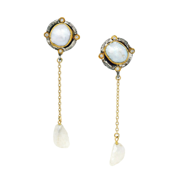 Close-up of natural pearl earrings featuring 22K gold and diamond cardinal point accents