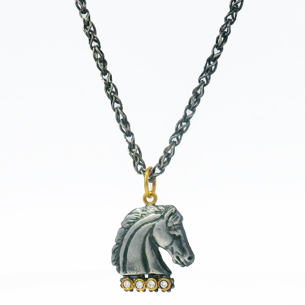 Necklace with a horse head pendant on a white background