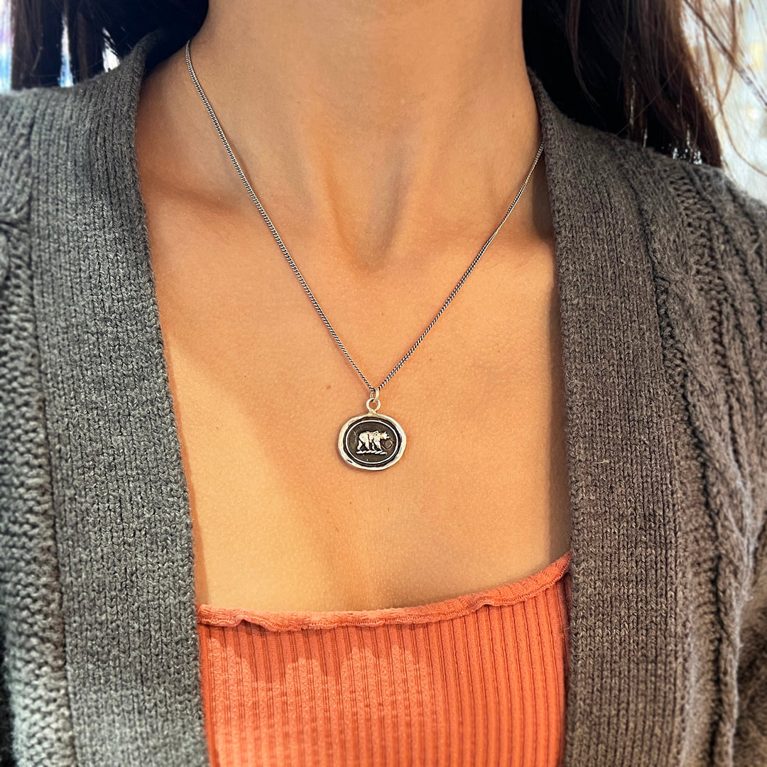 Woman wearing Mother Bear talisman necklace by Pyrrha from Alara Jewelry
