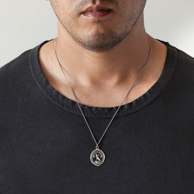 man wearing wolf and moon talisman necklace by Pyrrha from Alara Jewelry