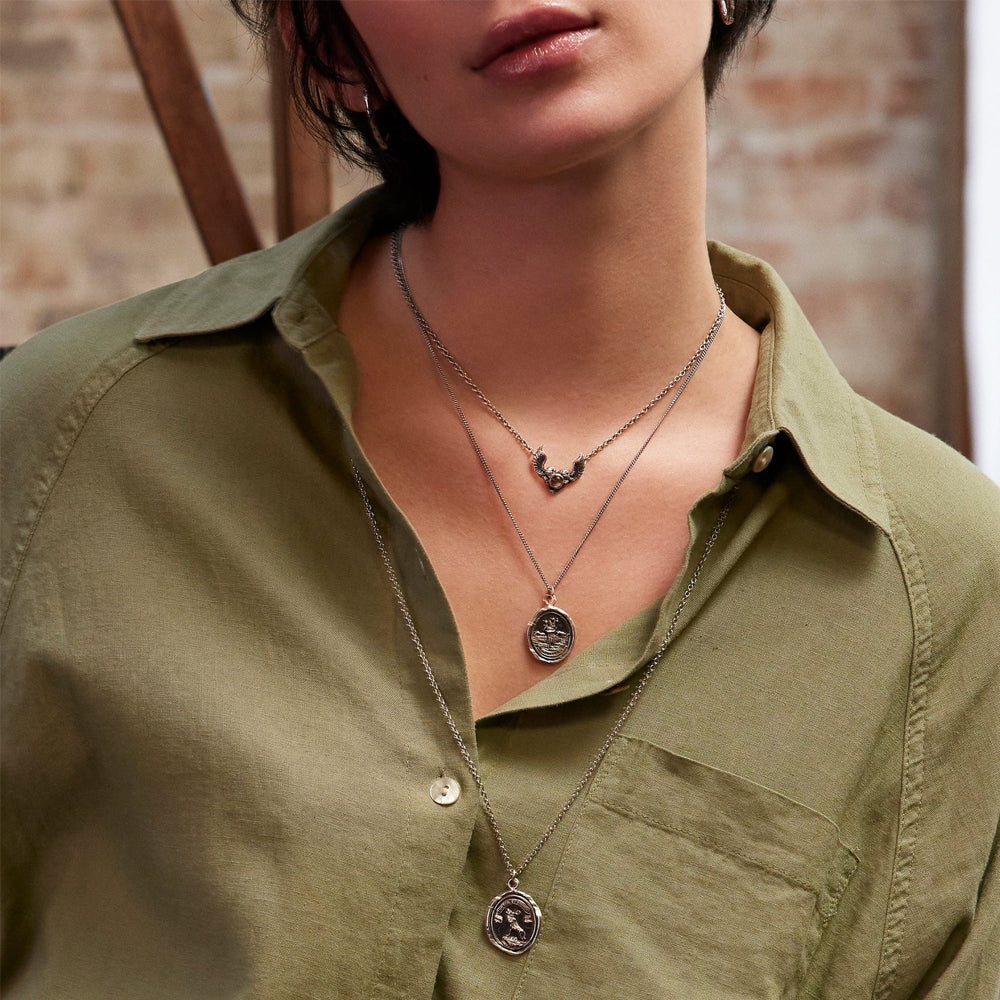 Woman wearing wolf and moon talisman necklace by Pyrrha from Alara Jewelry