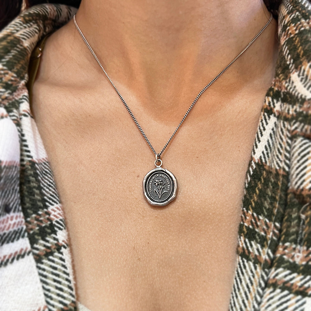 Woman wearing daylily talisman necklace from Alara Jewelry