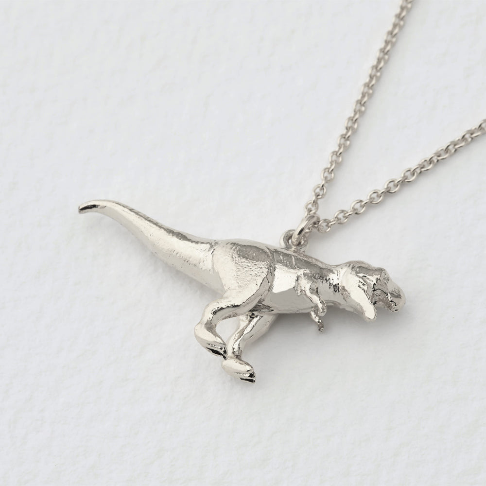 Close-up of detailed T-Rex pendant showing sculptural texture