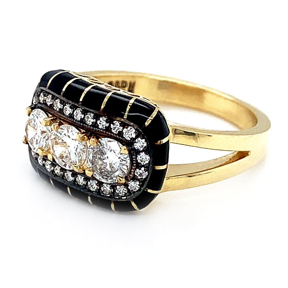 Side  view of an 18k yellow gold ring featuring a halo of round diamonds surrounding three larger center brilliant-cut diamonds with black enamel detailing.