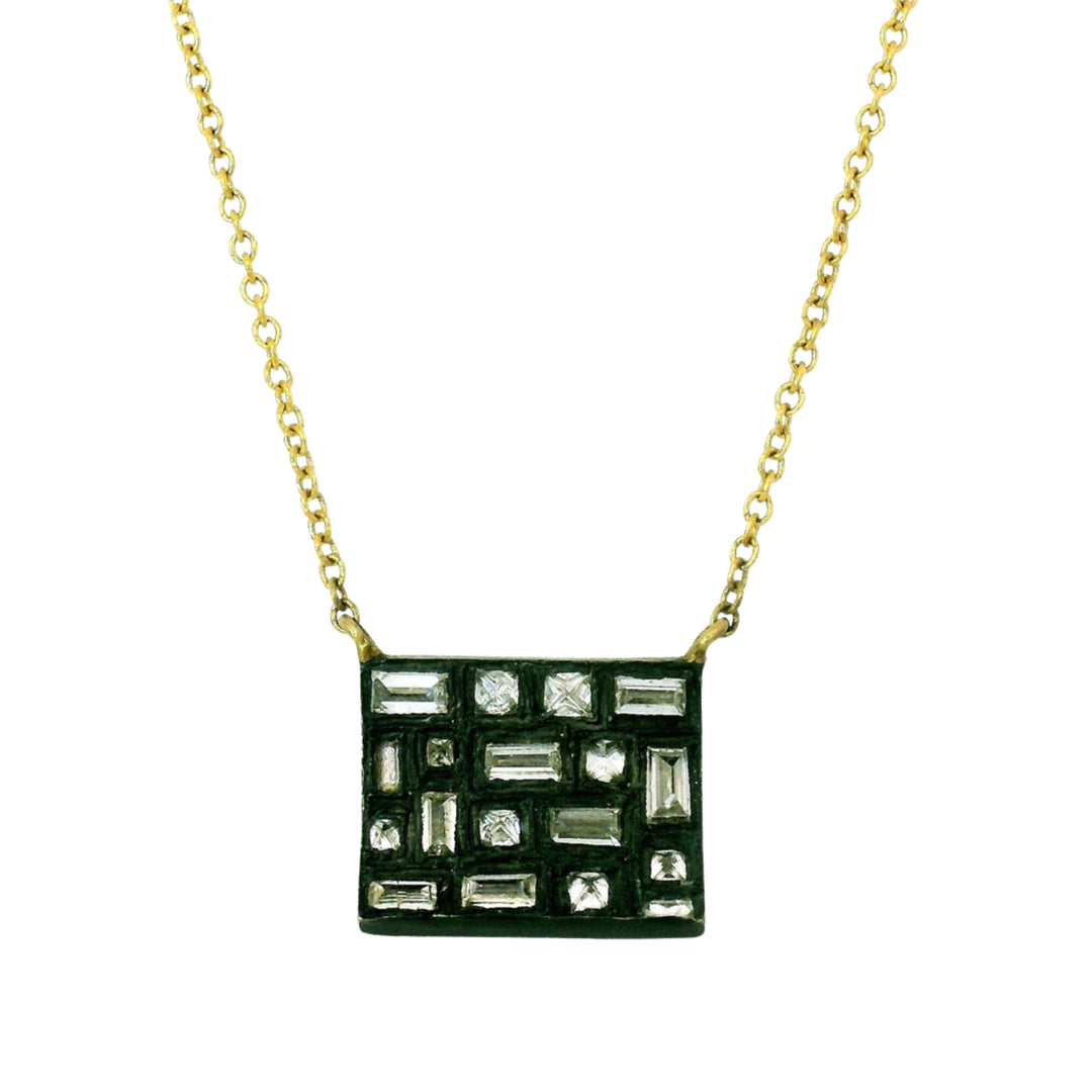 Close-up of geometric diamond arrangement in oxidized silver pendant