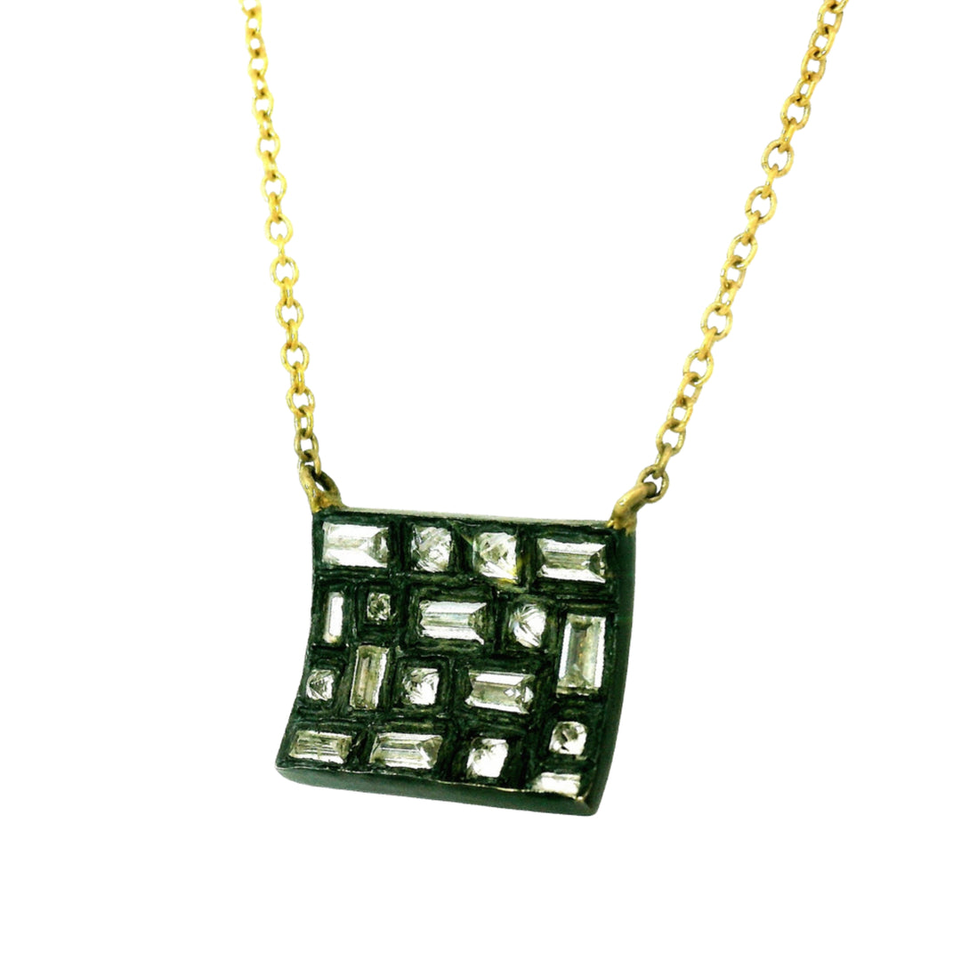 Close-up side view of geometric diamond arrangement in oxidized silver pendant