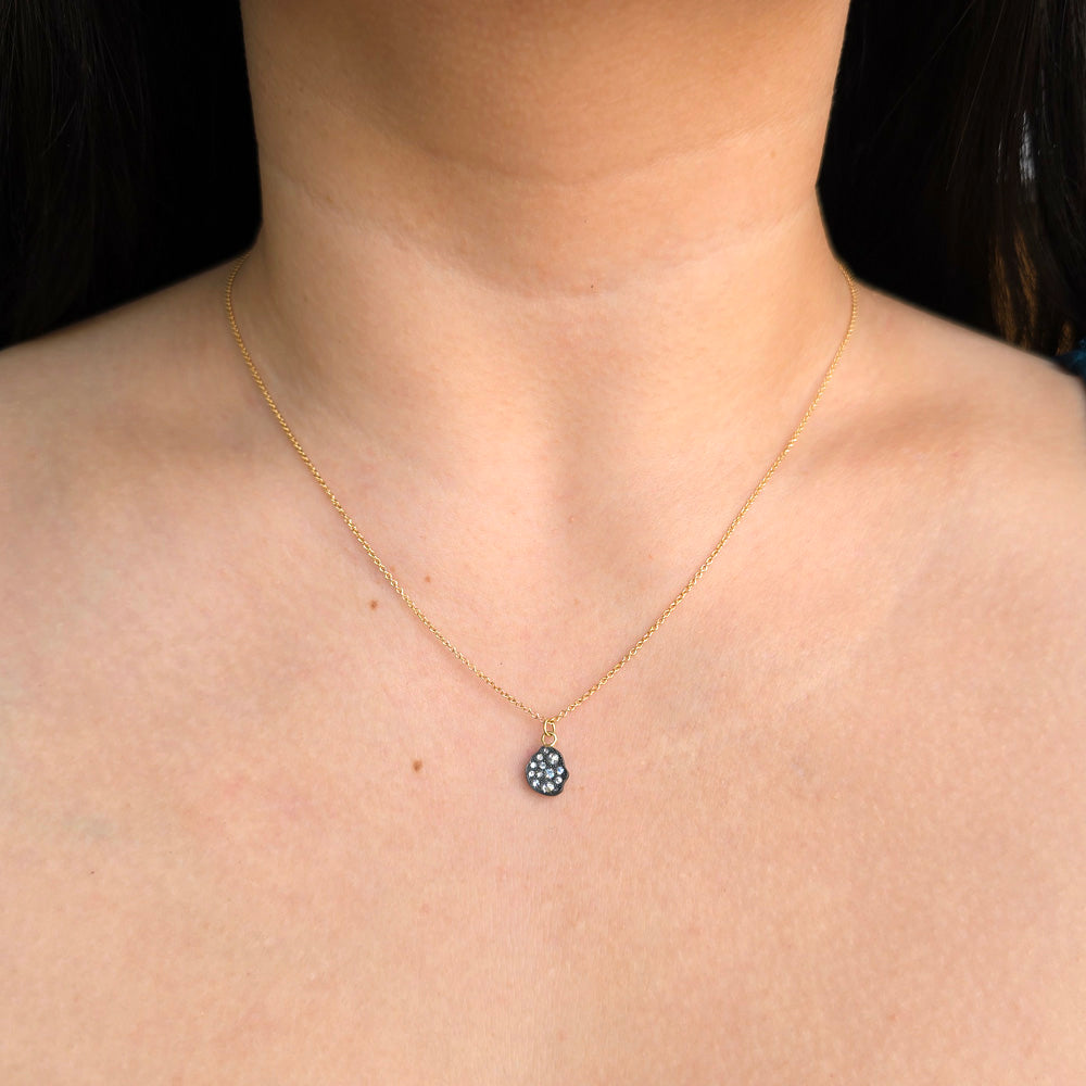 Freeform diamond pendant with scattered inverted diamonds