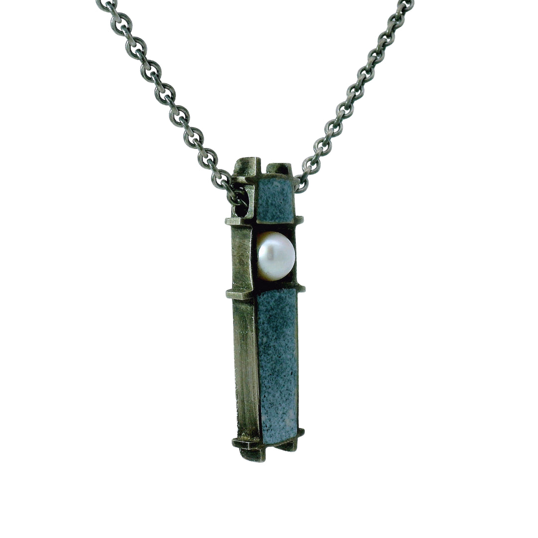 Close-up of blue-gray enamel and pearl detail on Three Box pendant