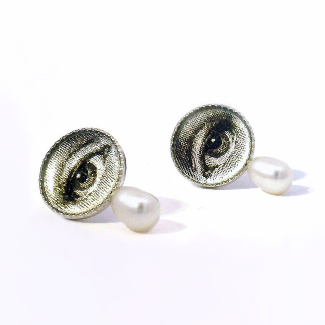 Close-up of hand-illustrated eye detail with pearl accent