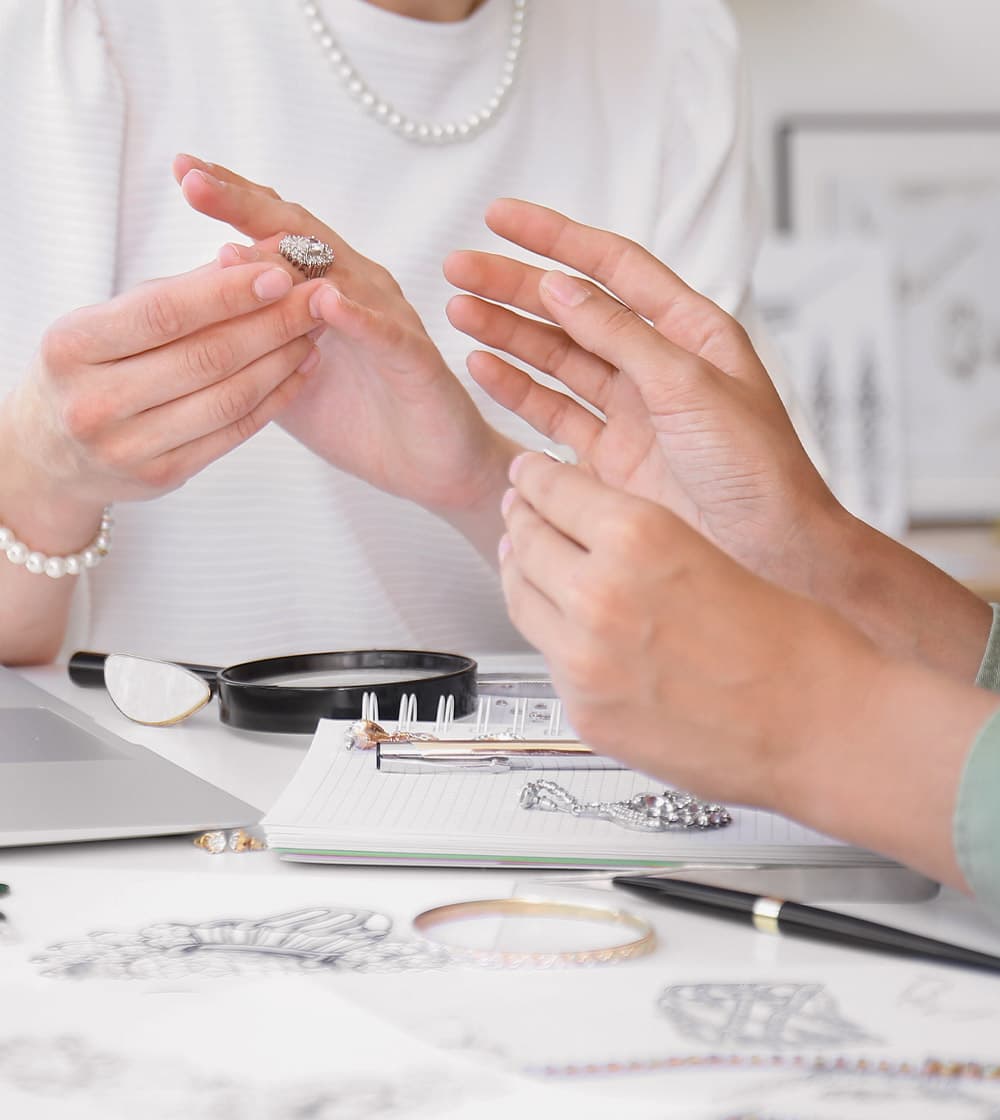 Custom jewelry client trying on bespoke jewelry with Alara designer.