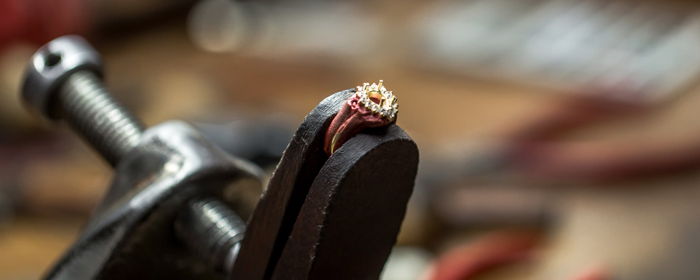 Jewelry clamp holding a custom ring in the creation process.