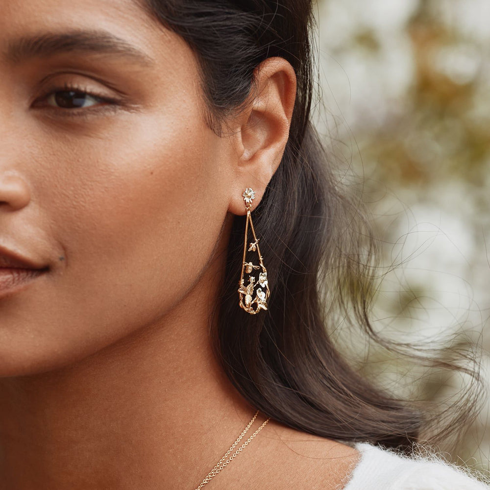 Woman wearing strawberry and bee earrings by Alex Monroe from Alara Jewelry