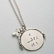 spinning "I love you" necklace. Crafted from sterling silver this adorable little pendant reveals its caring message only when being spun.
