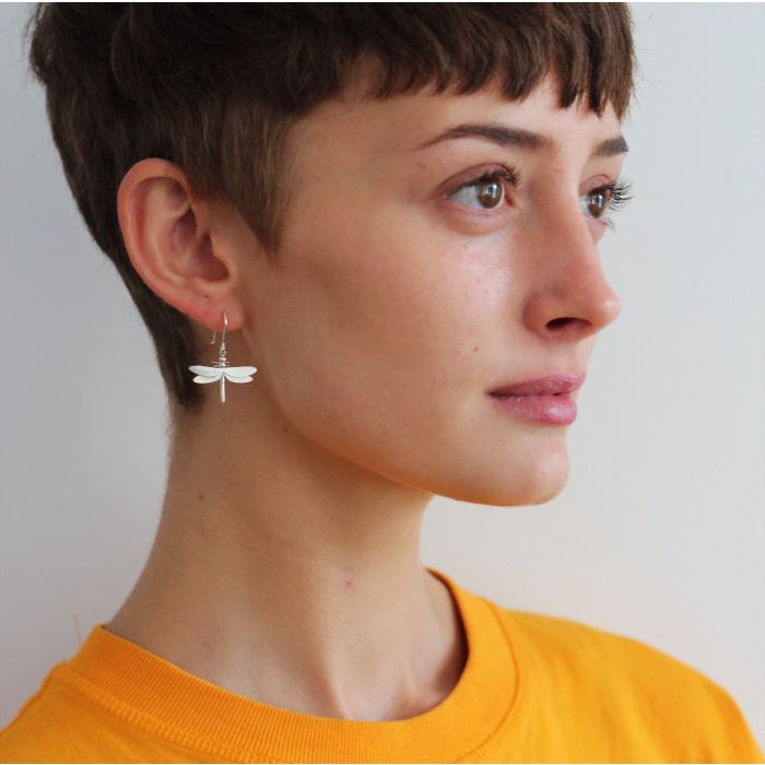 Woman wearing dragonfly drop earrings by Alex Monroe from Alara Jewelry